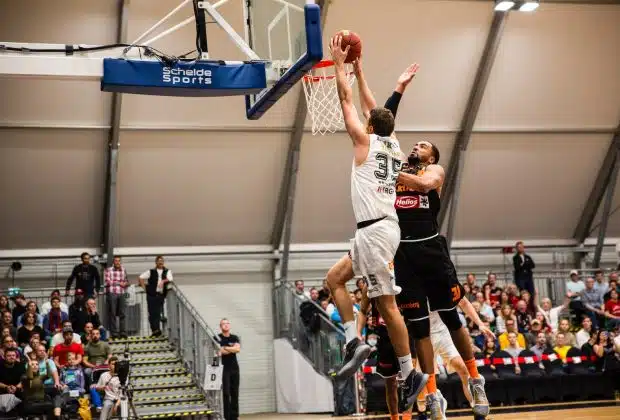 man holding ball dunk in ring